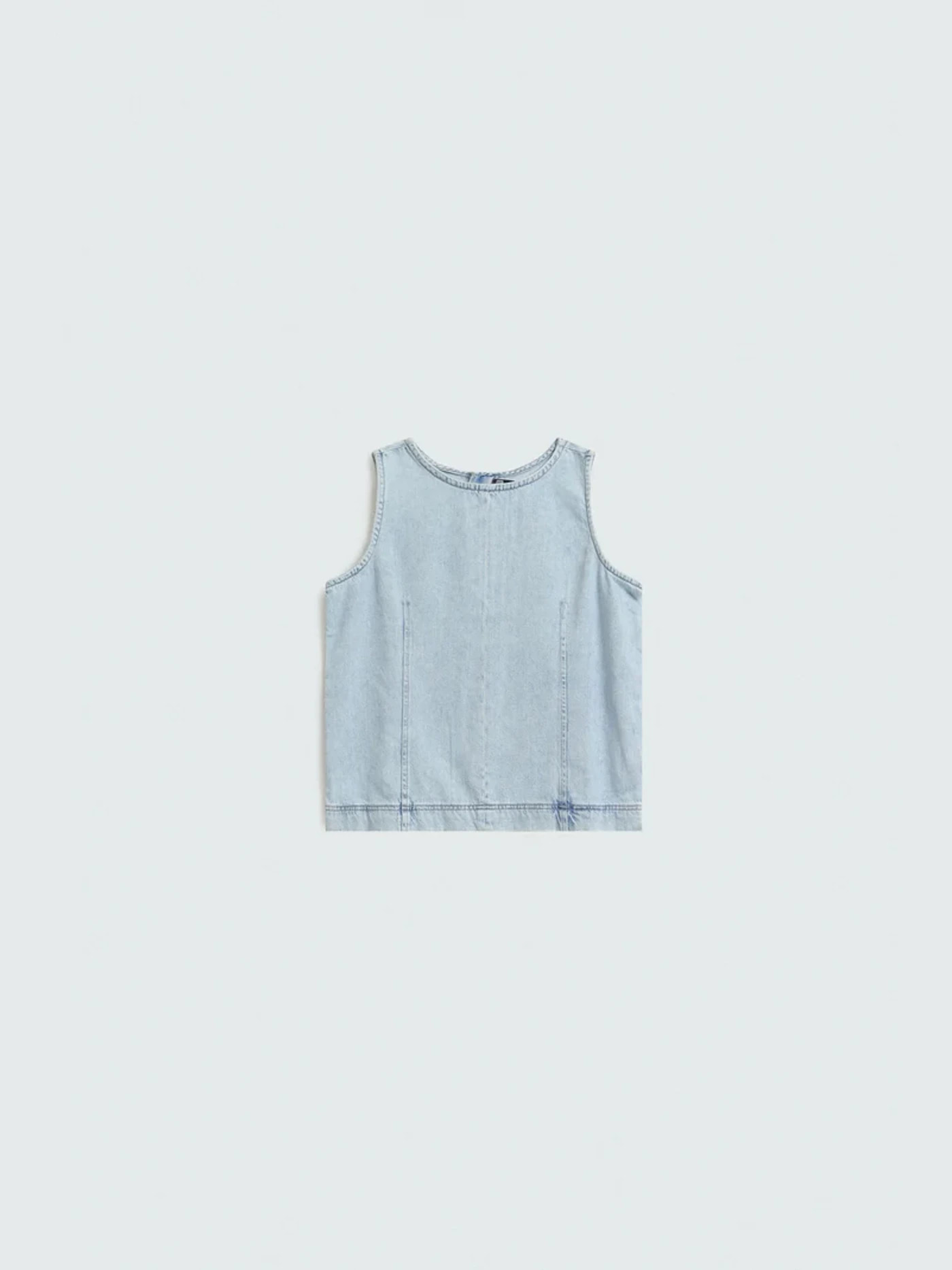 A denim top photographed flat, the input a brand supplies to Nokkh